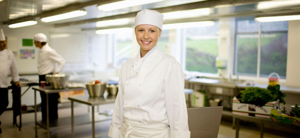 Young chef managing time in cafe